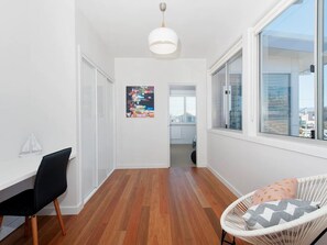 Experience a functional and contemporary living space with a compact kitchen, seating area, and workspace.