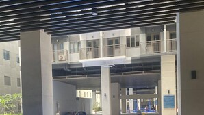 A swimming pool with a tiled floor, surrounded by a covered area with a roof structure. - 1 BR Fully Furnished Condo Across MOA with Pool and Parking - S Res. Unit 0916 (Pasay)