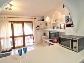 Enjoy cooking and dining in this well-equipped kitchen with a flat-screen TV and microwave.