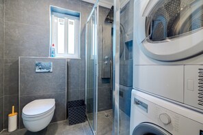 Shower, rainfall showerhead, hair dryer, towels