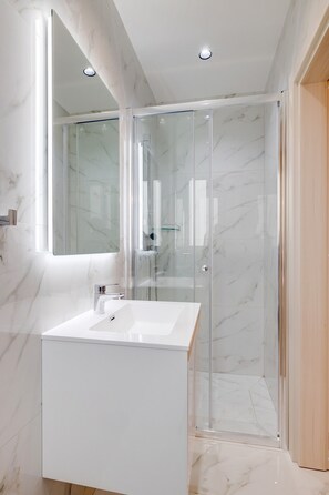 Shower, rainfall showerhead, towels, toilet paper
