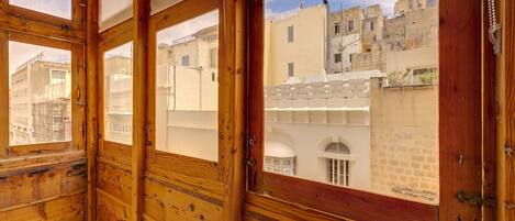 A wooden-framed room with large windows overlooking a cityscape.