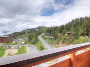 A mountain road with buildings and trees.