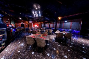 A restaurant with marble flooring, multiple dining tables, and chairs. - Royal Sapphire Hotel (Baku)