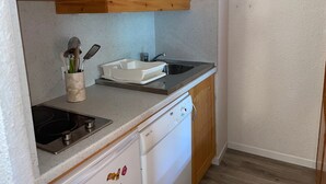 A compact kitchen with a microwave, sink, stove, and dishwasher. - Functional Studio for 4 · Ski-in/Ski-out at Plagne Villages (Plagne Villages)