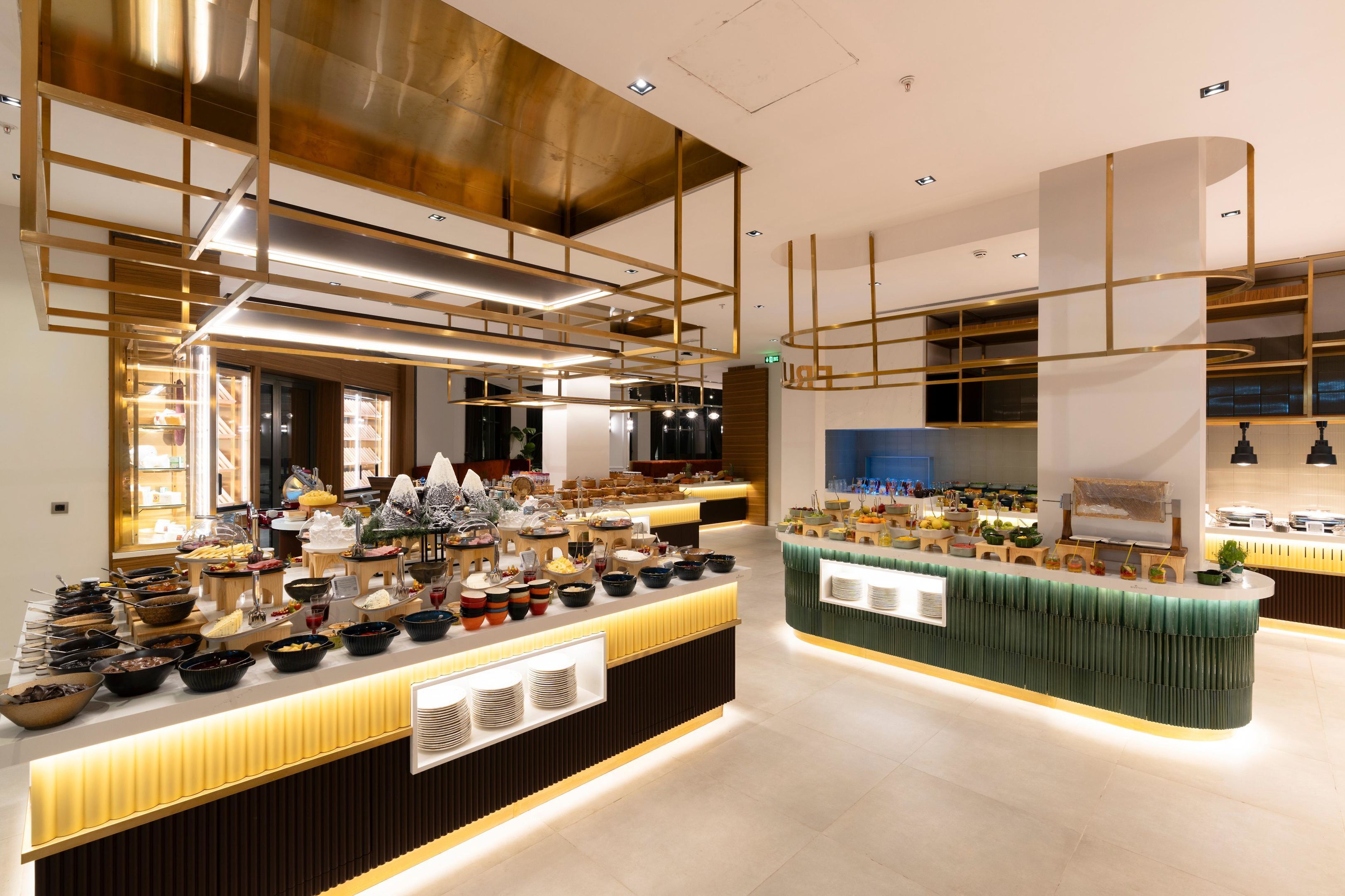 A modern buffet setup with multiple food stations, including a variety of dishes and beverages.