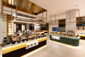 A modern buffet setup with multiple food stations, including a variety of dishes and beverages. - Megasaray Mount Erciyes (Kayseri)