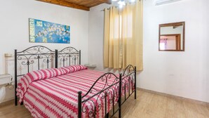 A bedroom with a bed, a painting, a mirror, and a ceiling fan. - Holiday Home 'Villa Relax Due' with Shared Pool & Wi-Fi (Galatone)