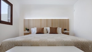 A bedroom with a large bed, a headboard, bedside tables, and a window. - Holiday Apartment "Crepusculo" with Mountain View, Terrace & Wi-Fi (Puerto del Rosario)