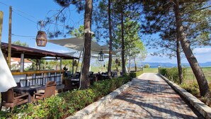 A paved pathway lined with trees, outdoor seating, and a view of the landscape. - Studio Apartment 'Alexandra Studio 11' with Private Balcony and Wi-Fi (Lefkimmi)
