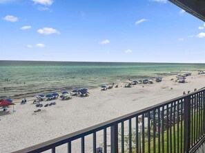 A beach with umbrellas and lounge chairs, a railing, and a view of the ocean. - GULF FRONT/Renovated-2 Bikes- Private Beach Access (Santa Rosa Beach)