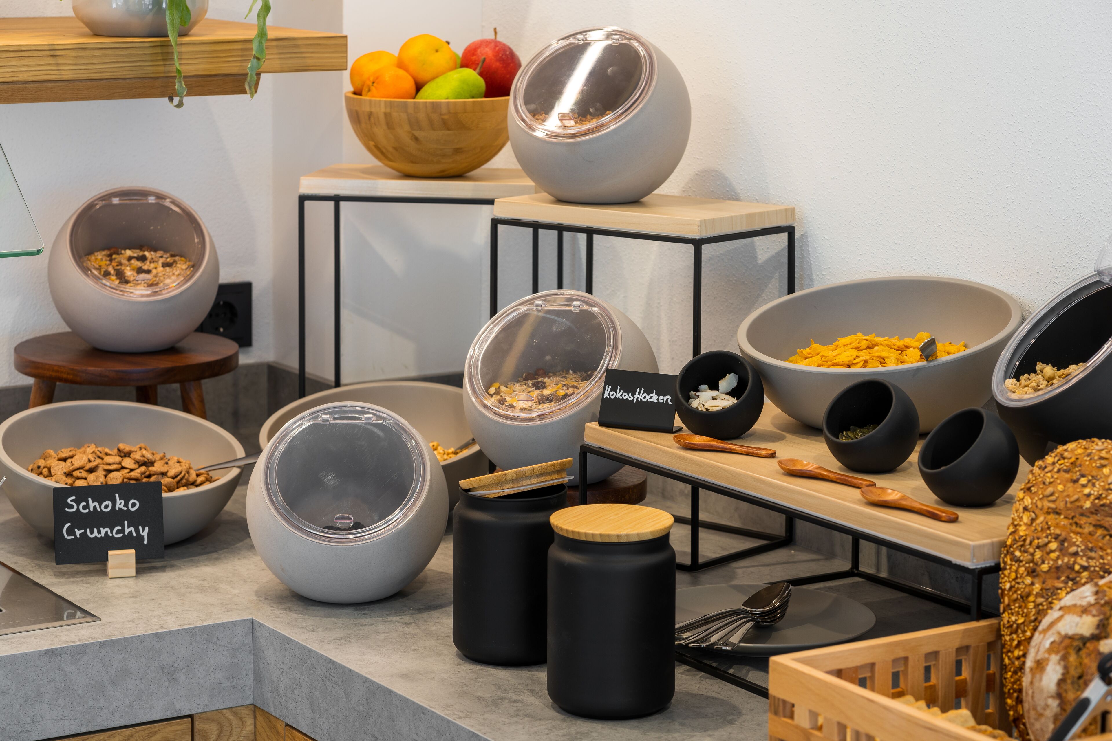 A buffet setup with various food items and containers.
