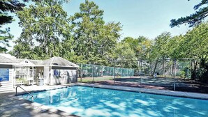 A swimming pool with a lifeguard station and a covered changing area.