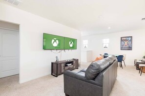 Flat-screen TV, video game console, table football, ping pong