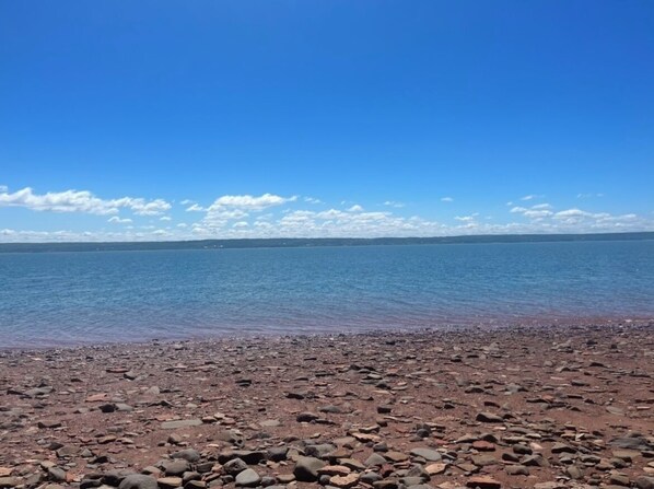Experience the serene tranquility of a secluded beach with a clear view of the ocean.