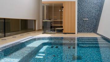 Swim in style with a clear glass-enclosed pool offering unobstructed views.