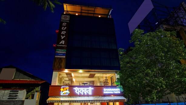 A hotel named "Surya Comforts" with a sign indicating "AC Non-AC Rooms" and "Lodging". - Treebo Surya Comforts, 200 Mtrs From Kolhapur Railway Station (Kolhapur)