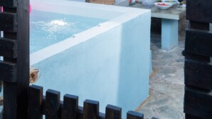 A wooden pergola with a sign for Dandy Villas, Sky Blue Pantry, and a stone-tiled outdoor seating area with tables and chairs. - Dandy Villas Tsagkarada | Sky Blue Pansy | Jacuzzi (Tsagkarada)