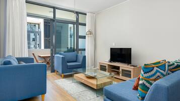 Signature Apartment | Living area | 42-inch flat-screen TV with cable channels, TV