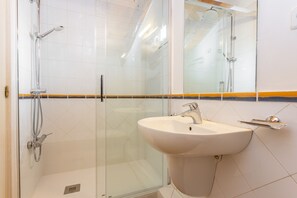 Shower, hair dryer, towels, toilet paper