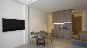 Deluxe Quadruple Room | Living area | 55-inch Smart TV with digital channels, TV