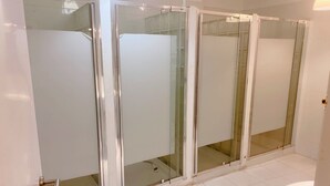 A bathroom with a glass-enclosed shower stall, a white bathtub, and a white toilet. - Cathedral Malaga Hostal - Hostel (Málaga)