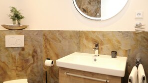 Een douche, een haardroger, handdoeken, toiletpapier
