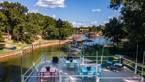 A lakeside deck with outdoor seating and a view of the lake.