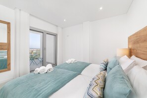 Relax in comfort with two single beds and a sliding door leading to a scenic outdoor area.