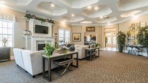 A spacious living room with a fireplace, comfortable seating, and a large TV. - TPV - Antilia - Luxury w/Indoor Heated Pool & Gym (Durham)
