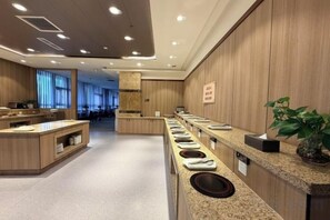 A modern hotel lobby with a long reception desk, a seating area, and a large window providing natural light. - Junrui Garden Hotel (Qianguo)
