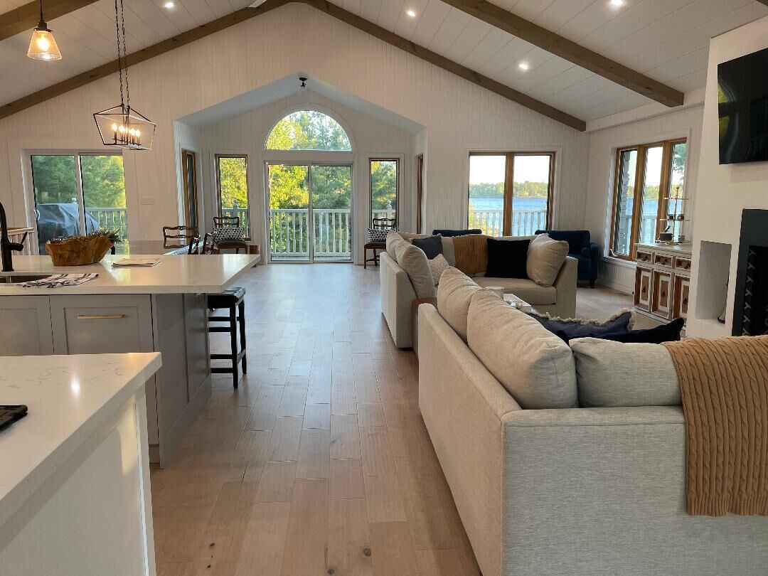Entrance to open concept living, dining & kitchen area, 2 fans, oversized couch