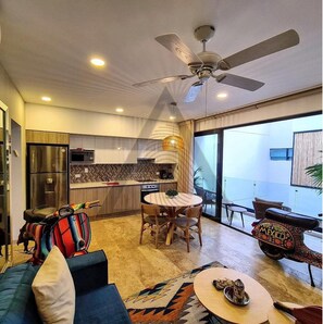 Enjoy a homey atmosphere in this living space with a kitchen, dining area, and comfortable seating.