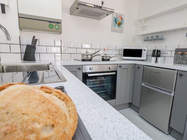 Une cuisine moderne équipée d’appareils électroménagers en acier inoxydable, d’un four à micro-ondes et d’un grille-pain.
