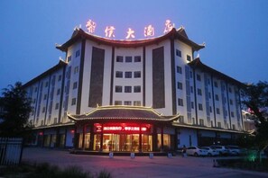 A building with a traditional architectural style, featuring a large entrance with illuminated signage.