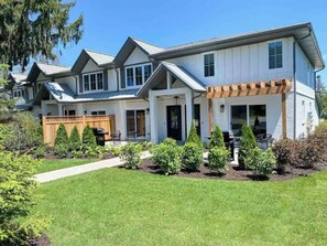 Stunning two-story home with a symmetrical facade and a charming covered porch.