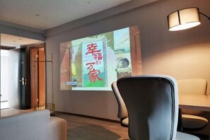 A conference room with a projection screen displaying a presentation, a modern chair, and a lamp. - Jinjiang Inn Select (Yangzhong Middle Yangzi Road) (Yangzhong)