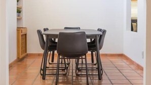 A dining area with a round table, six chairs, and a spherical pendant light. - Spacious Arcadia Lite house w/ pool, mtn. views (Phoenix)