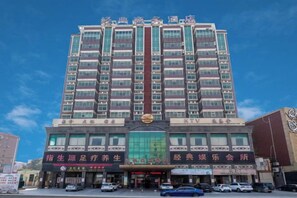 A multi-story hotel with a prominent entrance and signage for various amenities. - Jingdian Hotel (Nan'an)