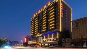 A multi-story hotel with illuminated signage and a prominent entrance. - Jingdian Hotel (Nan'an)