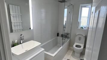 Bathtub, hair dryer, towels, soap