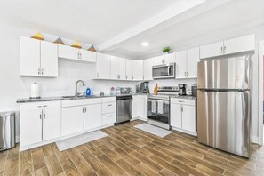 Enjoy cooking in this well-equipped kitchen with a microwave, oven, and refrigerator.