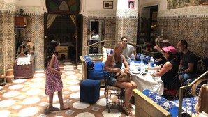 A traditional Moroccan interior with patterned tiles, a central seating area, and a chandelier. - RIAD ABQARI YOUSSEFI (Fes)