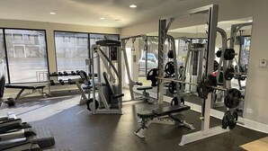 A gym with various exercise equipment, including treadmills, weight machines, and free weights. - Walk to Ole Miss Games, Oxford Square - 2 Master Suites - Patio - Near Stadium! (Oxford)