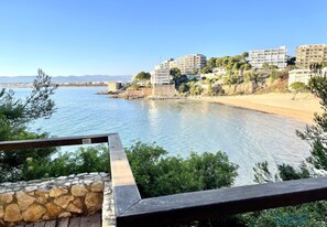 Enjoy breathtaking views of the serene beach from this balcony.