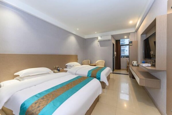 A hotel room with two beds, a desk, a TV, and a window. - Liang Mao Boutique Hotel (Wusheng)