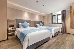 A hotel room with two beds, a nightstand, a window with curtains, and a wooden floor. - Nanfang Yijing Hotel (Shenzhen Baoan International Airport Gushu Subway Station store) (Shenzhen)