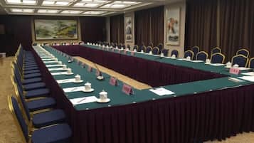 A conference room with a long table, chairs, and nameplates.