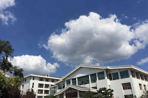 A multi-story building with large windows and a flat roof.