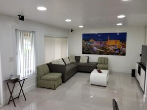 Relax in this stylish living room with a comfortable sofa, side table, and flat-screen TV.